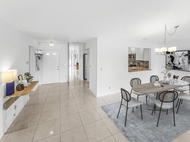 tiled dining room featuring an inviting chandelier