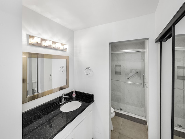 bathroom with tile patterned floors, a shower with door, and toilet