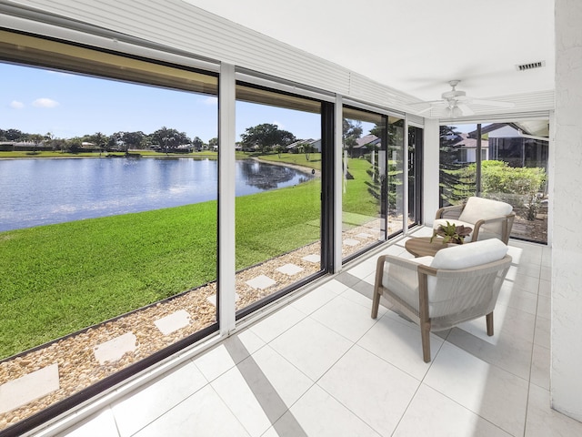 unfurnished sunroom with a water view and ceiling fan