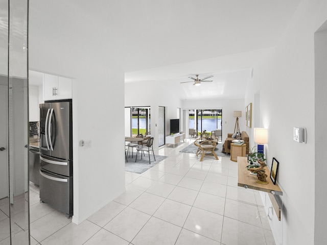 tiled living room featuring ceiling fan and lofted ceiling