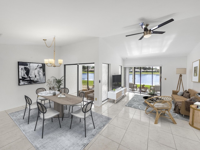 tiled dining area with ceiling fan with notable chandelier and vaulted ceiling