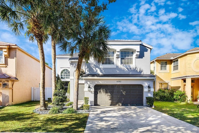 mediterranean / spanish-style home with a front yard and a garage