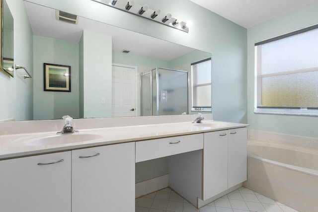 bathroom with tile patterned floors, vanity, and shower with separate bathtub