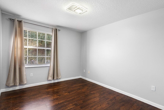 empty room featuring hardwood / wood-style floors and a textured ceiling