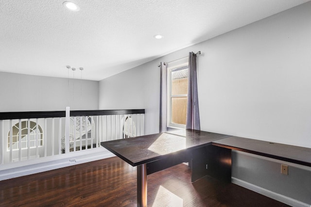 unfurnished office featuring a textured ceiling and hardwood / wood-style flooring