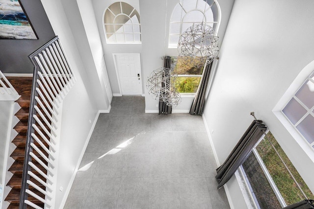 entrance foyer with a towering ceiling and a notable chandelier