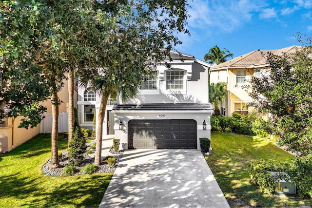 view of front of property featuring a garage and a front lawn