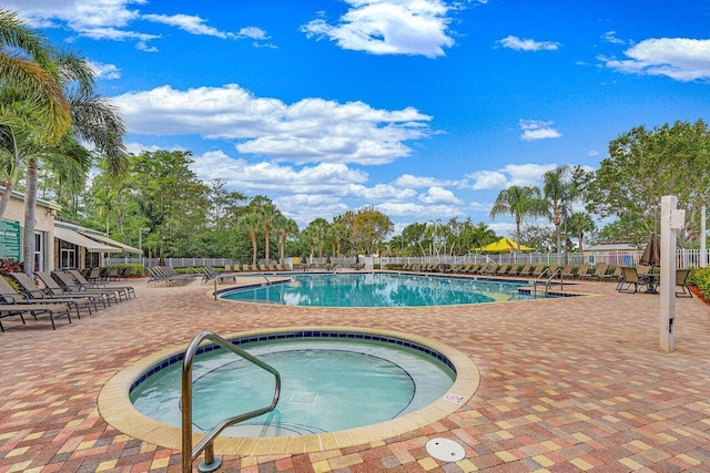 view of swimming pool featuring a community hot tub and a patio