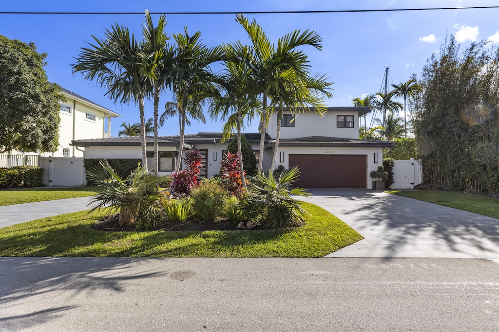 view of front of property featuring a garage and a front lawn