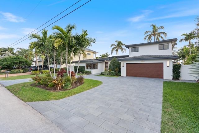 view of front of house with a garage and a front yard