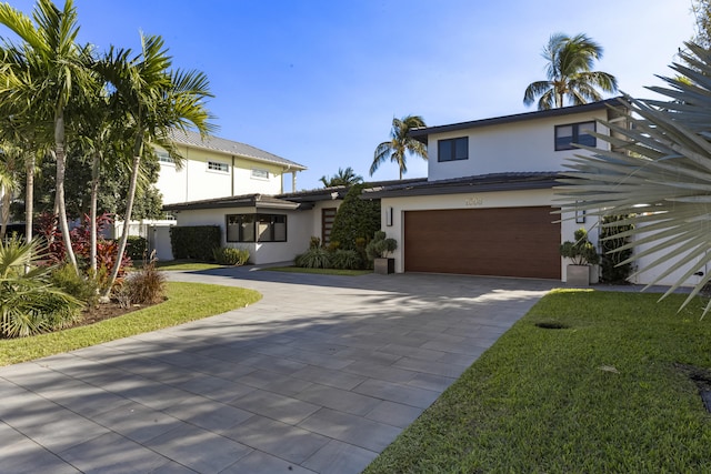 view of front facade with a front yard and a garage