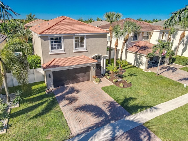 mediterranean / spanish-style home featuring a garage and a front yard