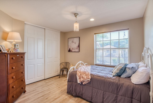 bedroom featuring light hardwood / wood-style floors and a closet