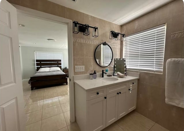 bathroom with tile patterned floors, vanity, and tile walls