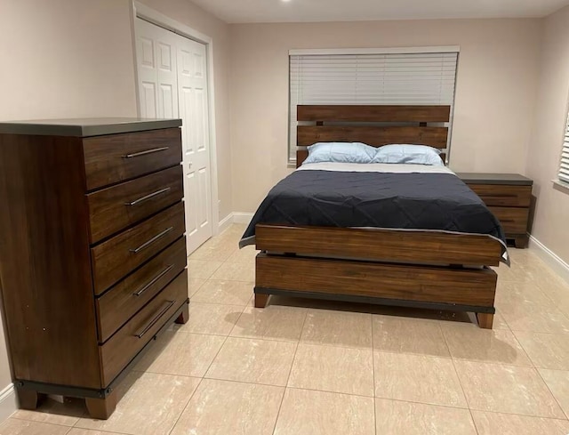 tiled bedroom featuring a closet