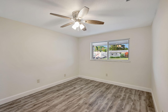 spare room featuring ceiling fan and light hardwood / wood-style flooring