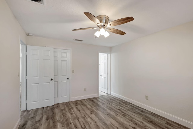 unfurnished bedroom featuring ceiling fan, a closet, and light hardwood / wood-style floors