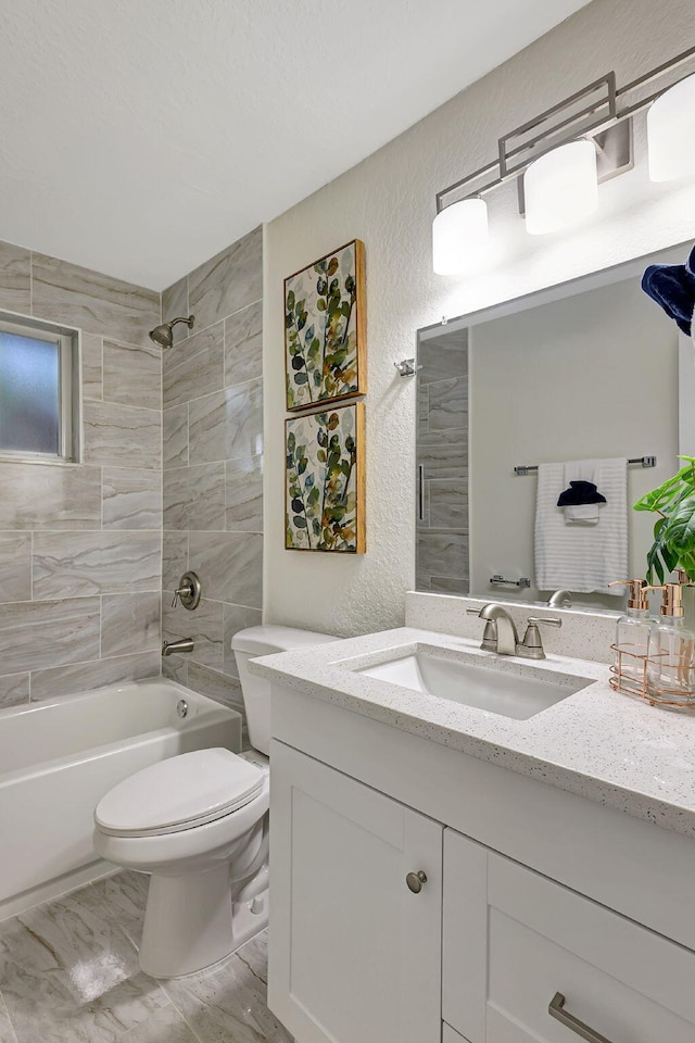 full bathroom featuring vanity, toilet, and tiled shower / bath combo