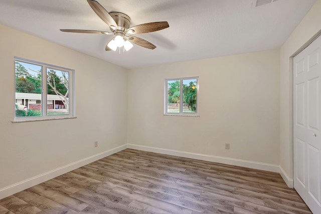 unfurnished bedroom featuring ceiling fan, a closet, and light hardwood / wood-style flooring