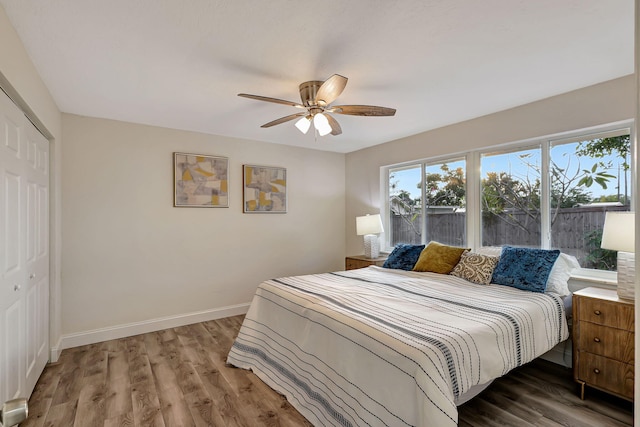 bedroom featuring wood-type flooring, a closet, and ceiling fan