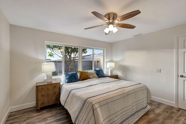 bedroom with hardwood / wood-style flooring and ceiling fan