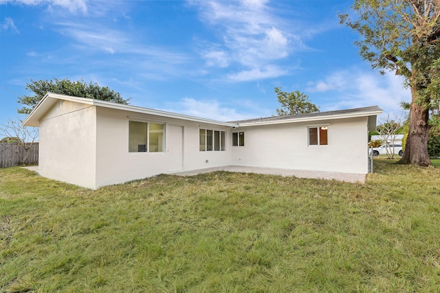 rear view of house featuring a yard