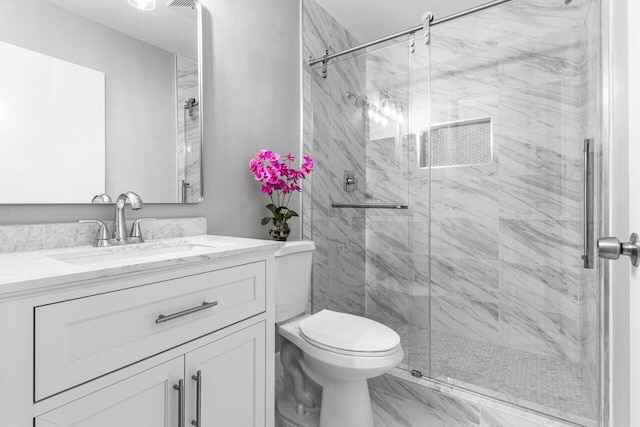 bathroom with vanity, an enclosed shower, and toilet