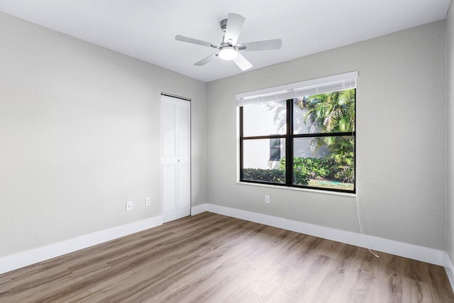 empty room with ceiling fan and hardwood / wood-style floors