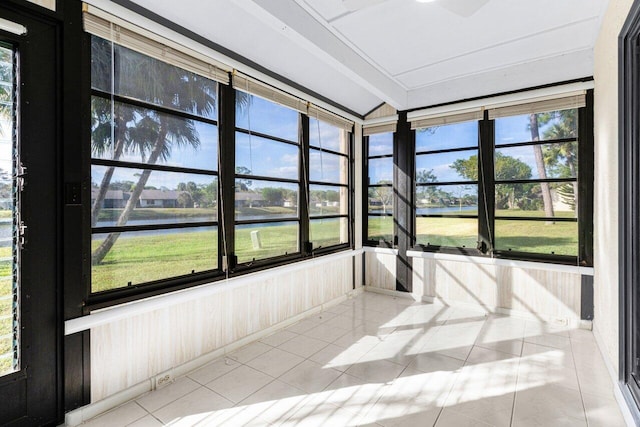 unfurnished sunroom featuring a water view and lofted ceiling with beams