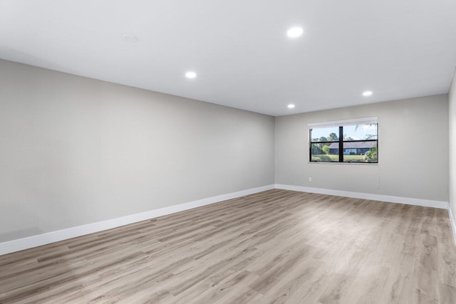 unfurnished room with light hardwood / wood-style floors