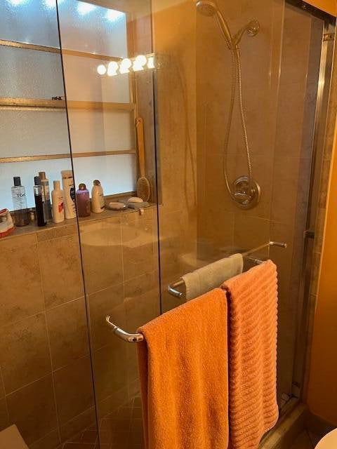 bathroom with a shower with shower door