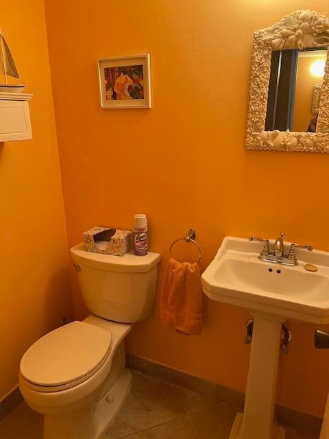 bathroom featuring toilet and tile patterned floors