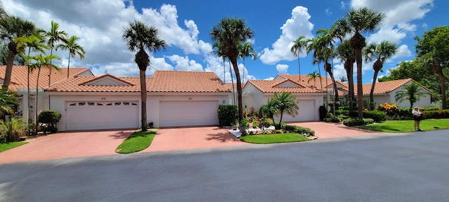 mediterranean / spanish-style house with a garage