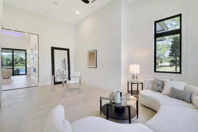 living room with ceiling fan and light hardwood / wood-style flooring