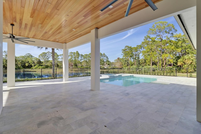 view of pool with a patio area, ceiling fan, and a water view