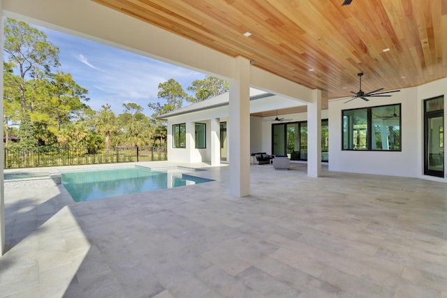 view of swimming pool with ceiling fan, outdoor lounge area, and a patio