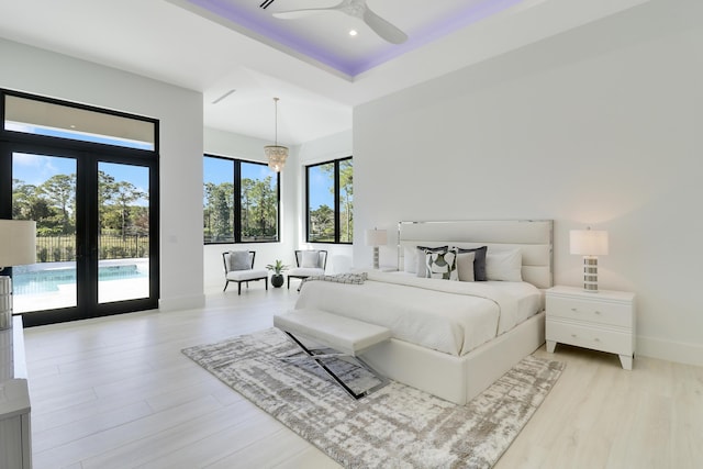 bedroom featuring french doors, light hardwood / wood-style floors, and access to outside