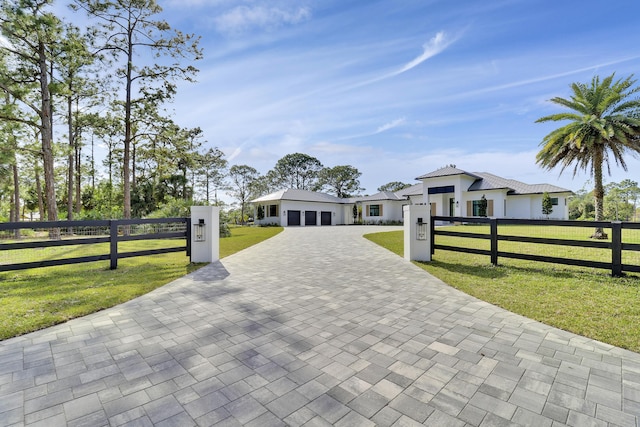 view of front of house with a garage and a front lawn