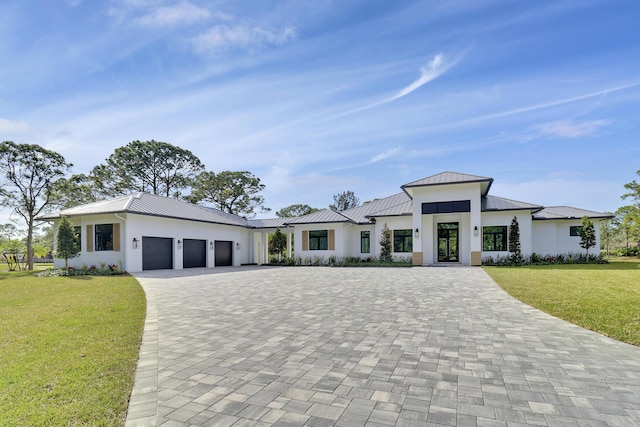 view of front of house with a garage and a front yard