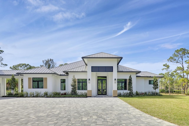 modern inspired farmhouse with french doors and a front lawn