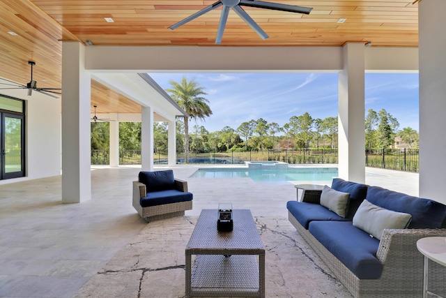 view of patio / terrace with a fenced in pool, an outdoor hangout area, and ceiling fan