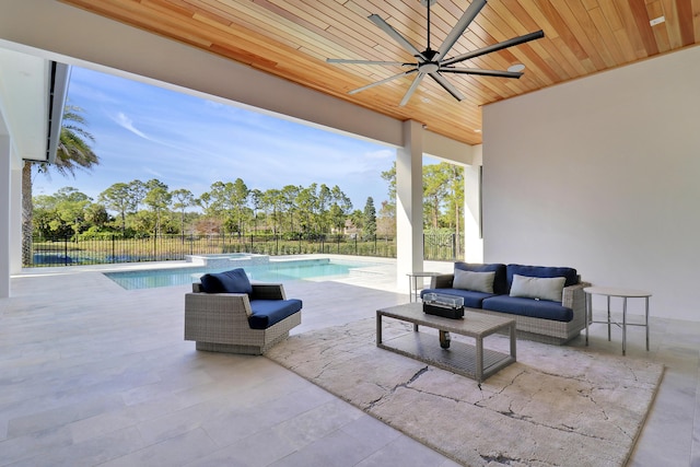 view of patio / terrace with a fenced in pool, an outdoor hangout area, and ceiling fan