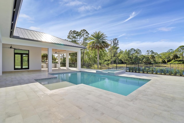 view of swimming pool with an in ground hot tub, ceiling fan, and a patio area