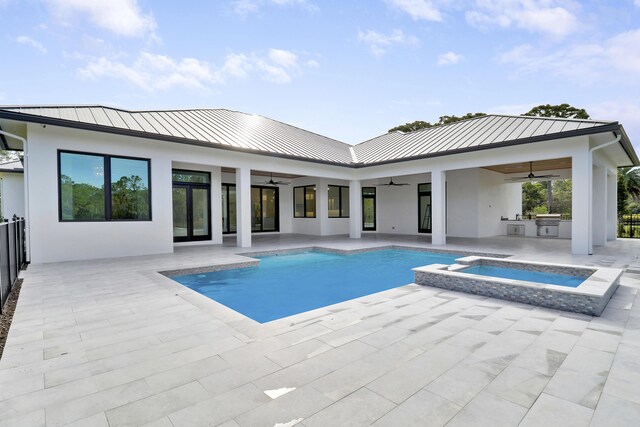 view of pool with ceiling fan, exterior kitchen, a patio, and an in ground hot tub