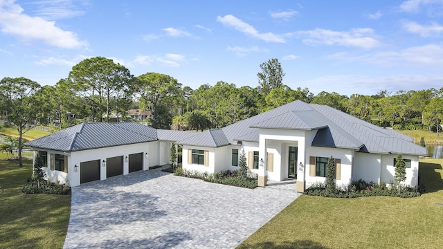 modern farmhouse featuring a garage and a front lawn