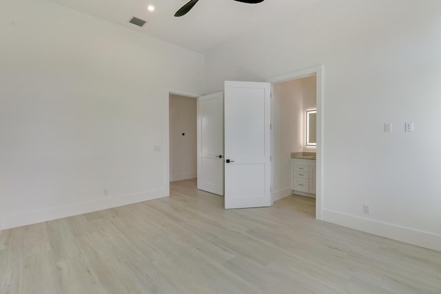 unfurnished bedroom featuring ensuite bathroom, ceiling fan, and light hardwood / wood-style floors