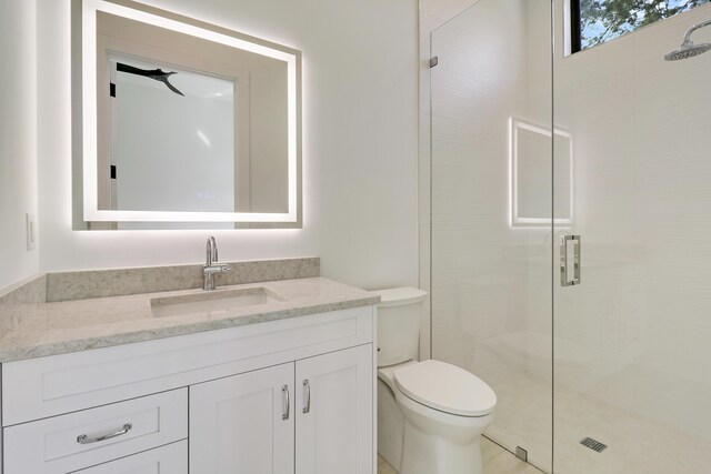 bathroom featuring ceiling fan, toilet, vanity, and an enclosed shower