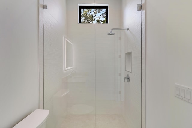 bathroom with a tile shower