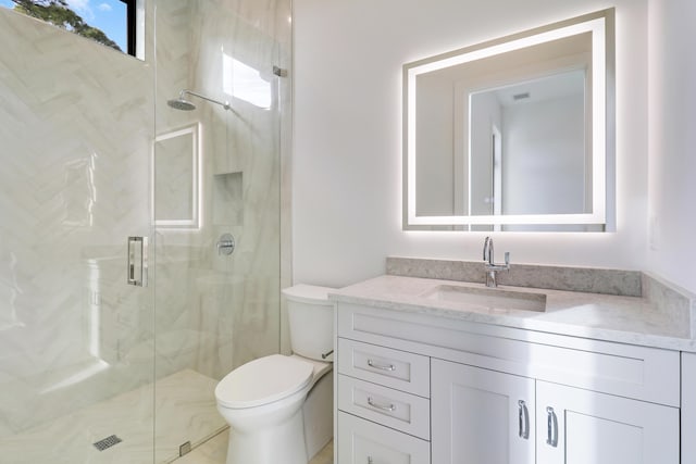 bathroom with toilet, a shower with door, and vanity