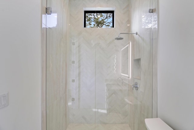 bathroom with a shower with door